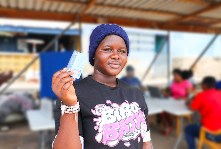 A community resident proudly displaying her newly acquired and active National Health Insurance Scheme (NHIS) card.